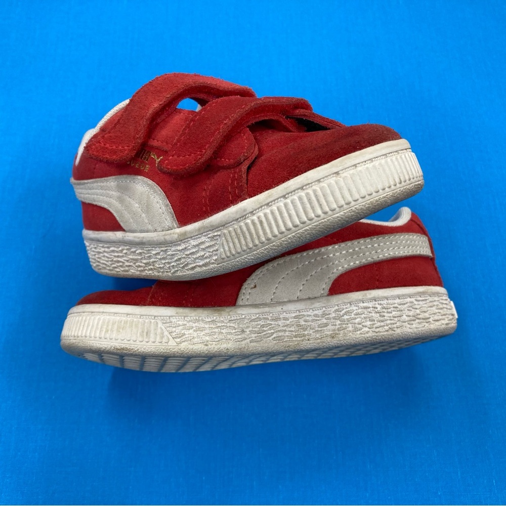 Classic Puma Suede toddler sneakers in bright red with Velcro strap closure.